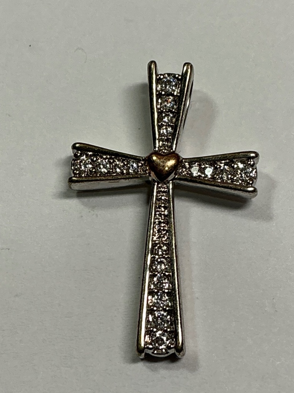 Silver Cross with clear stones and gold Color heart. 1 inch long